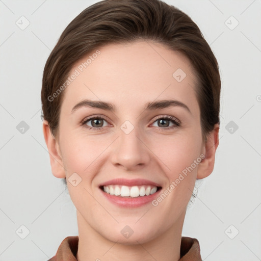 Joyful white young-adult female with short  brown hair and grey eyes