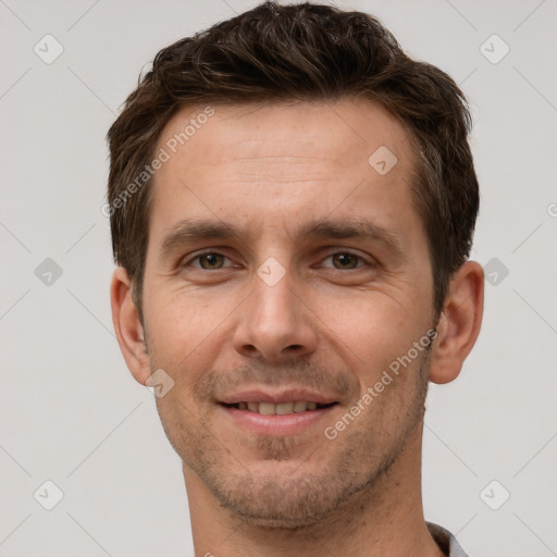 Joyful white young-adult male with short  brown hair and grey eyes