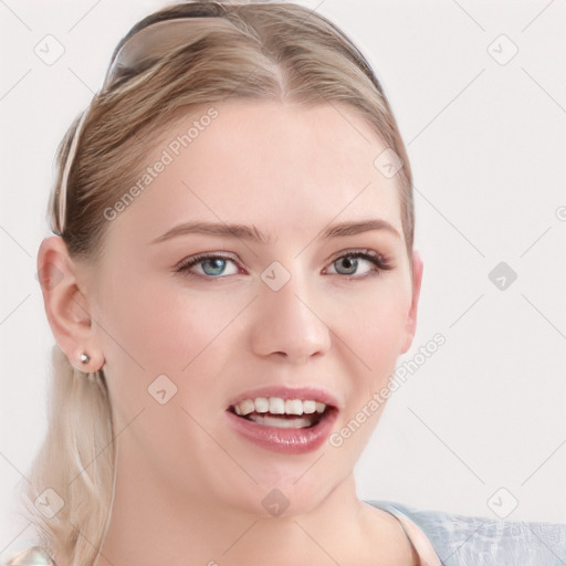 Joyful white young-adult female with long  brown hair and blue eyes