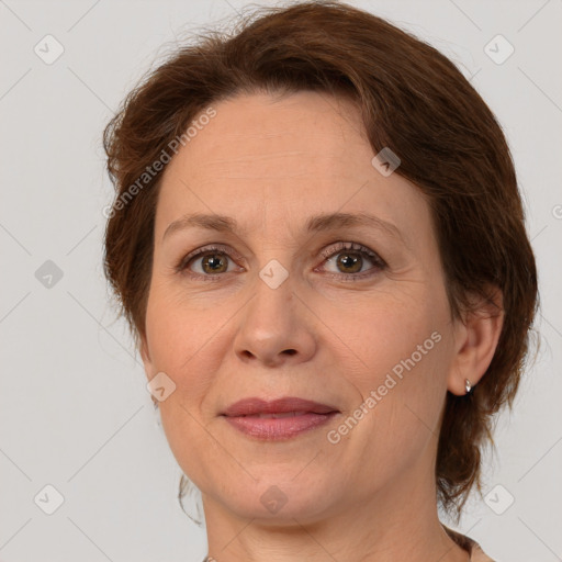 Joyful white adult female with medium  brown hair and green eyes