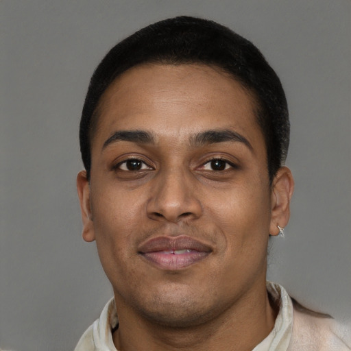 Joyful black young-adult male with short  brown hair and brown eyes