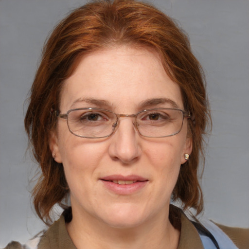 Joyful white adult female with medium  brown hair and blue eyes