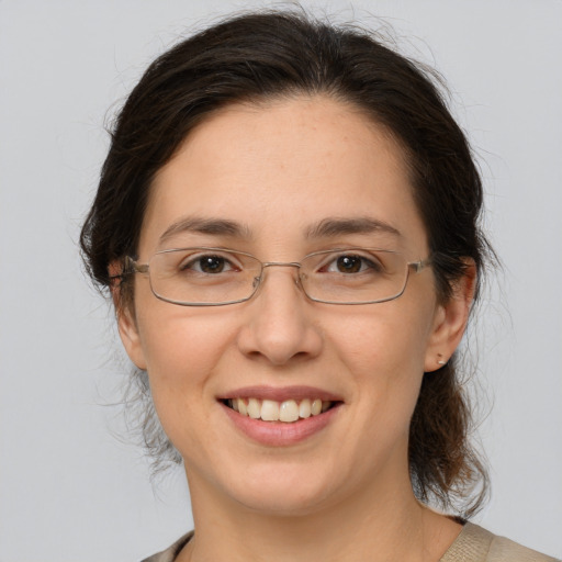 Joyful white adult female with medium  brown hair and brown eyes