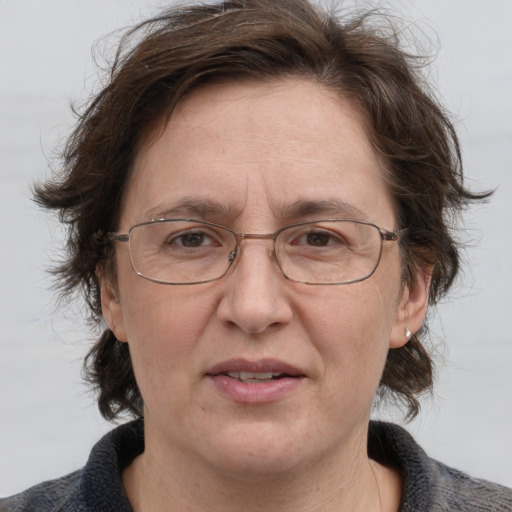 Joyful white middle-aged female with medium  brown hair and grey eyes