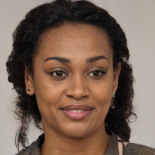 Joyful black young-adult female with medium  brown hair and brown eyes