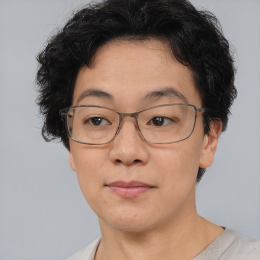 Joyful asian adult female with short  brown hair and brown eyes