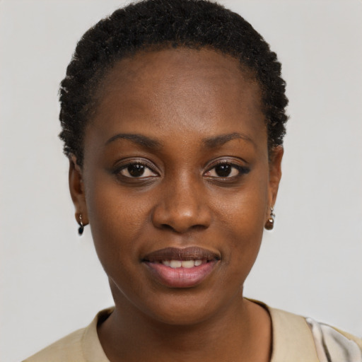 Joyful black young-adult female with short  black hair and brown eyes