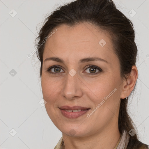 Joyful white adult female with long  brown hair and brown eyes