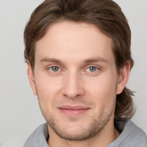 Joyful white adult male with short  brown hair and grey eyes