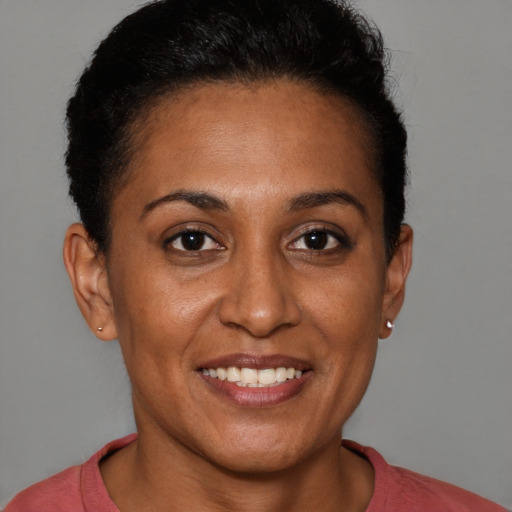 Joyful black adult female with short  brown hair and brown eyes