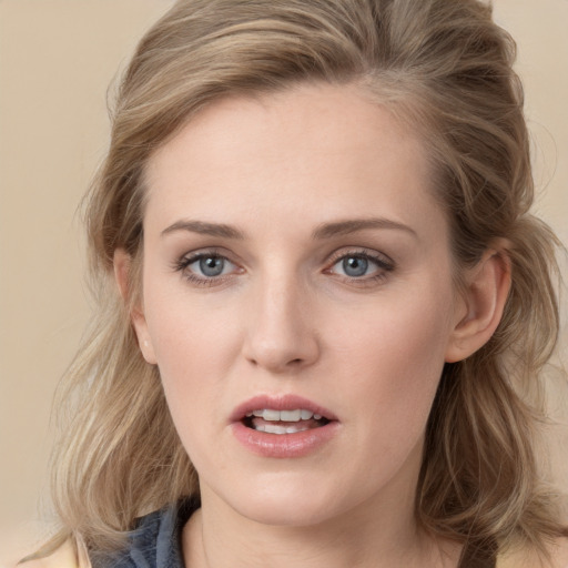 Joyful white young-adult female with medium  brown hair and blue eyes