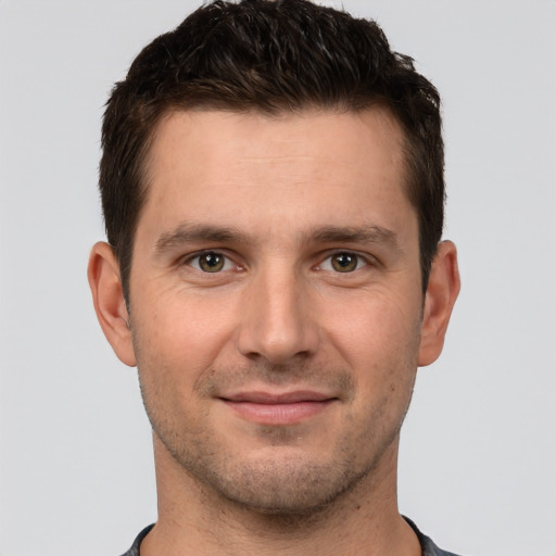 Joyful white young-adult male with short  brown hair and brown eyes