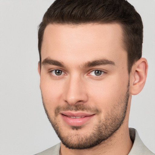 Joyful white young-adult male with short  brown hair and brown eyes