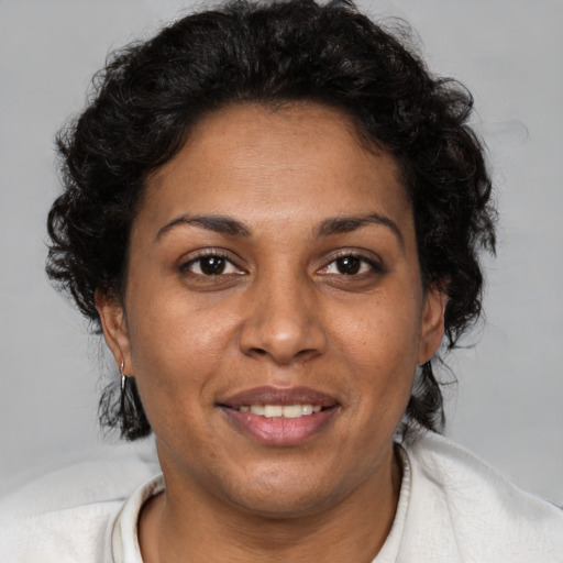 Joyful black adult female with short  brown hair and brown eyes