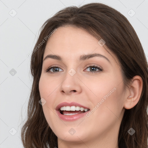 Joyful white young-adult female with long  brown hair and grey eyes