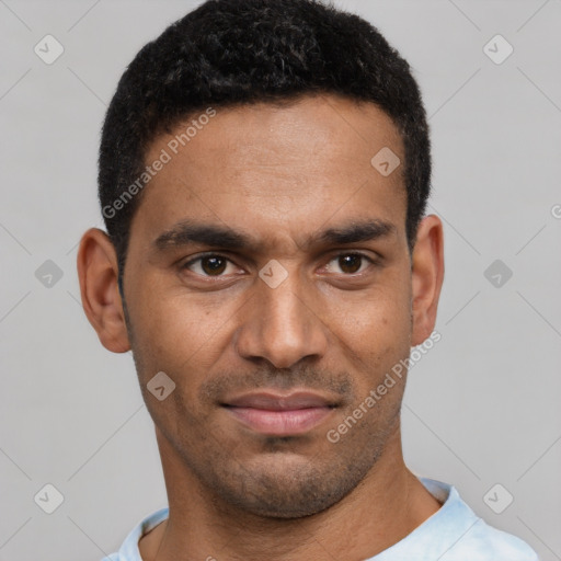 Joyful black young-adult male with short  black hair and brown eyes
