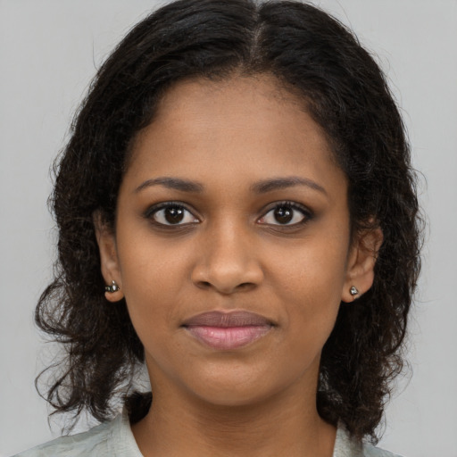 Joyful black young-adult female with medium  brown hair and brown eyes