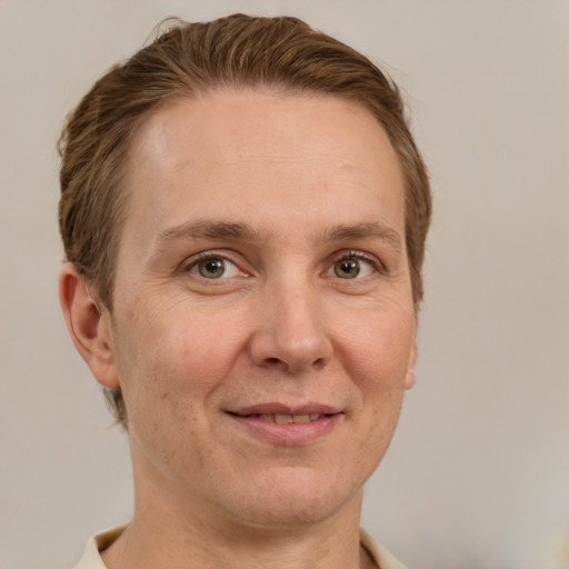 Joyful white adult female with short  brown hair and grey eyes