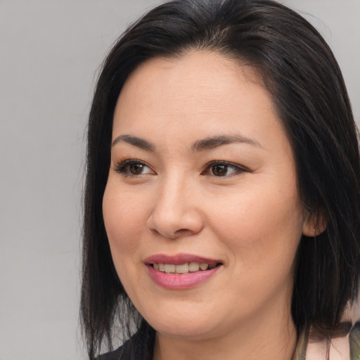 Joyful asian young-adult female with medium  brown hair and brown eyes