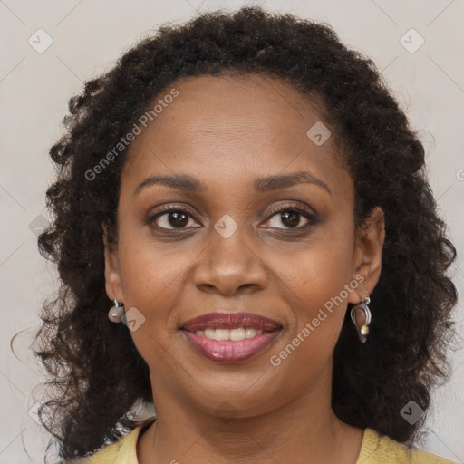 Joyful black adult female with medium  brown hair and brown eyes