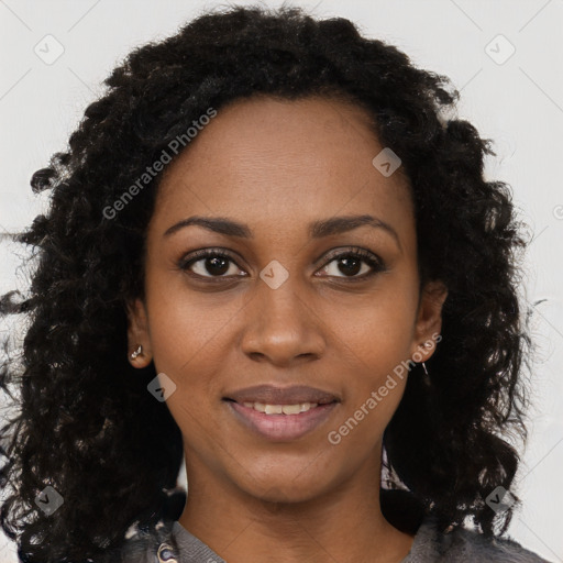 Joyful black young-adult female with long  brown hair and brown eyes