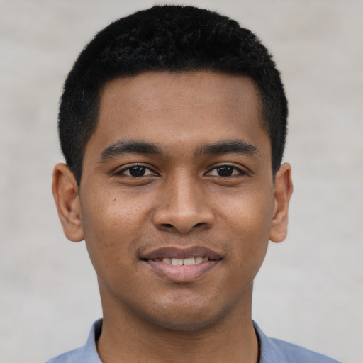 Joyful latino young-adult male with short  brown hair and brown eyes