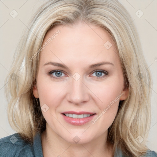 Joyful white young-adult female with medium  brown hair and blue eyes