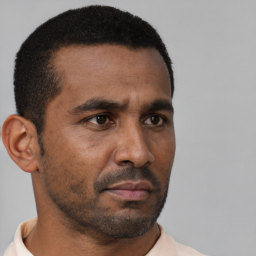 Neutral black adult male with short  brown hair and brown eyes