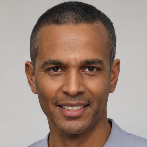 Joyful latino adult male with short  black hair and brown eyes