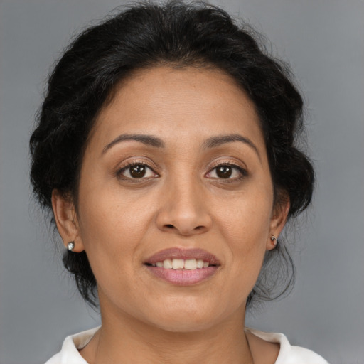 Joyful latino adult female with medium  brown hair and brown eyes