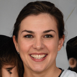 Joyful white young-adult female with medium  brown hair and green eyes