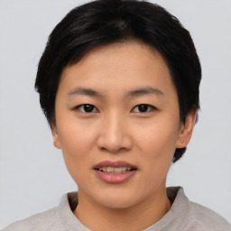 Joyful asian young-adult female with short  black hair and brown eyes