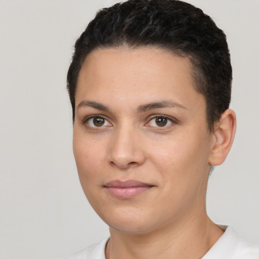 Joyful white young-adult female with short  black hair and brown eyes