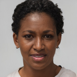 Joyful black adult female with short  brown hair and brown eyes