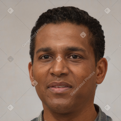 Joyful black adult male with short  black hair and brown eyes