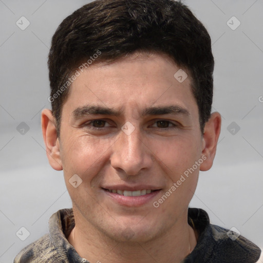 Joyful white young-adult male with short  brown hair and grey eyes