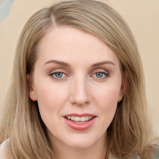 Joyful white young-adult female with long  brown hair and blue eyes