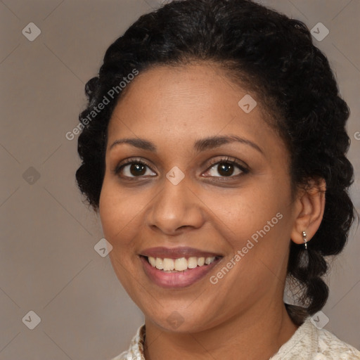 Joyful black young-adult female with medium  brown hair and brown eyes