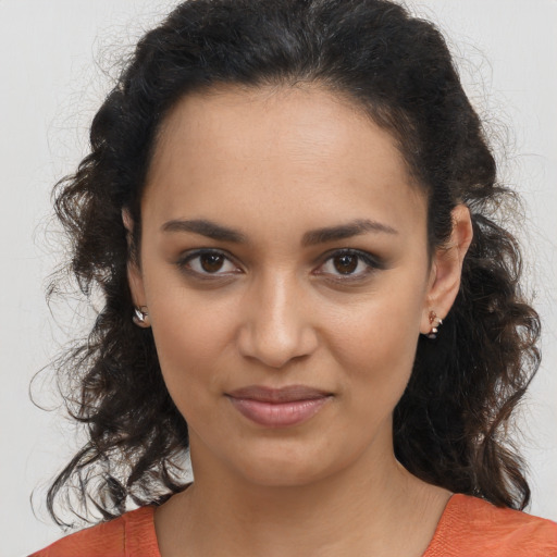 Joyful latino young-adult female with medium  brown hair and brown eyes