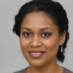 Joyful black young-adult female with medium  brown hair and brown eyes