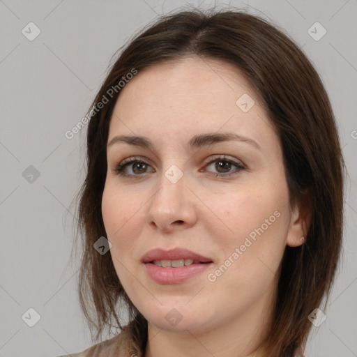 Joyful white adult female with medium  brown hair and brown eyes