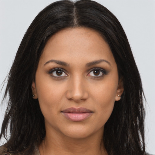 Joyful latino young-adult female with long  brown hair and brown eyes