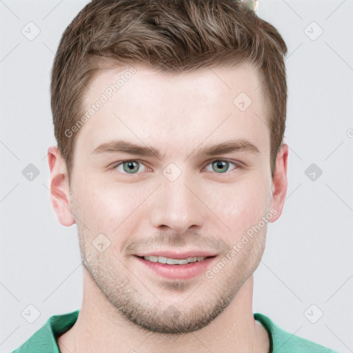 Joyful white young-adult male with short  brown hair and grey eyes