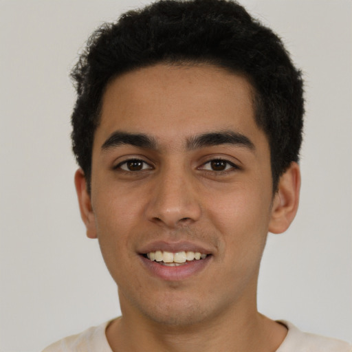 Joyful latino young-adult male with short  black hair and brown eyes