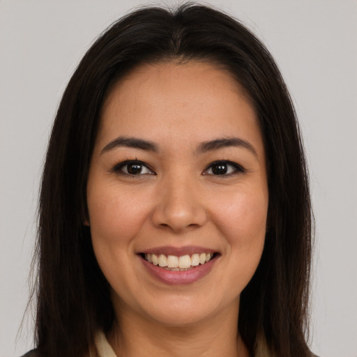 Joyful latino young-adult female with long  brown hair and brown eyes