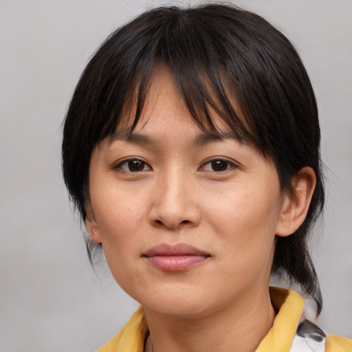 Joyful asian young-adult female with medium  brown hair and brown eyes