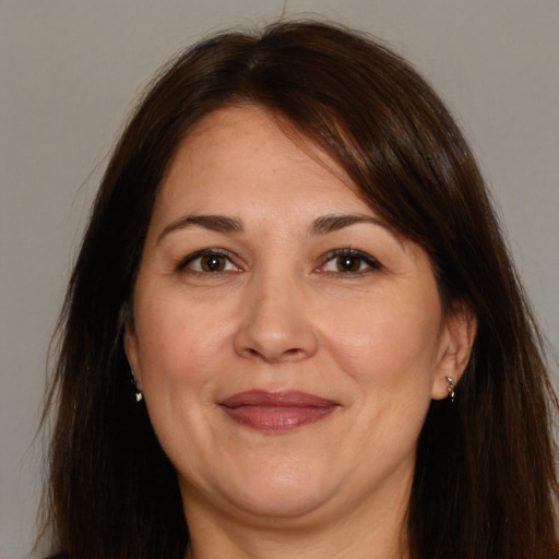 Joyful white adult female with long  brown hair and brown eyes