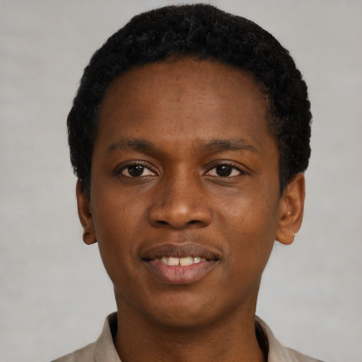 Joyful black young-adult male with short  black hair and brown eyes