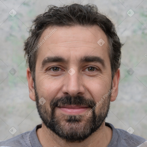 Joyful white adult male with short  black hair and brown eyes