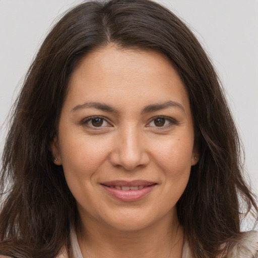Joyful white young-adult female with long  brown hair and brown eyes